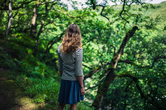 Young woman standing in the forest