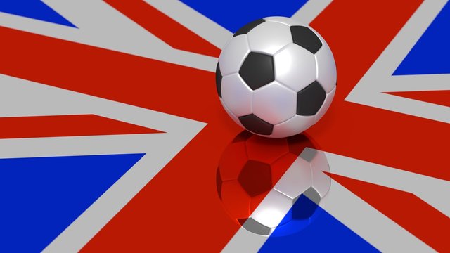 Black and white soccer ball on a reflecting britisch flag