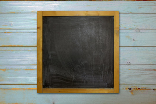 Blackboard on wood old blue wall.