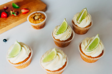 .Cupcakes with cream and lime. Baking.