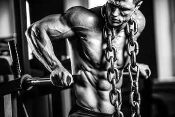 Brutal Caucasian bodybuilder training chest in gym