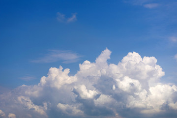 Fluffy cumulus clouds on blue sky