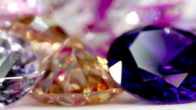 Blue Diamond,tourmaline pink,Amethyst Purple,Citrine Yellow,Iolite smokey blue,
Topaz lighter blue,Peridot green,and colorful gems in white background.
