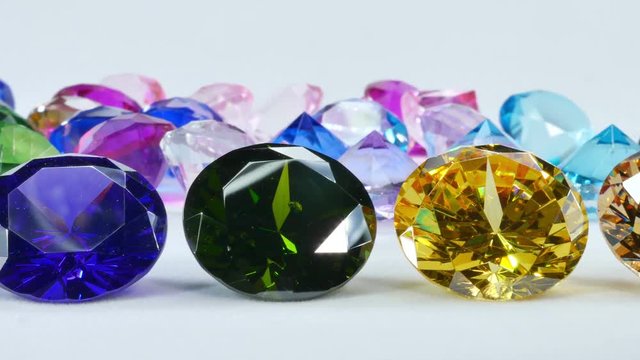 Blue Diamond,tourmaline pink,Amethyst Purple,Citrine Yellow,Iolite smokey blue,
Topaz lighter blue,Peridot green,and colorful gems in white background.
