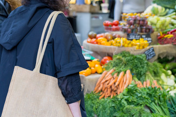 Young woman shopping for produce at farmers market