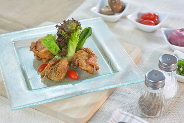 Deep fried chicken with soy sauce on glass plate