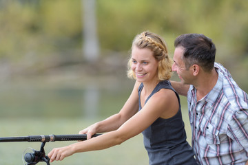 man and woman fly fishing in river