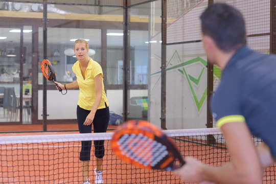 playing padel tennis indoor court