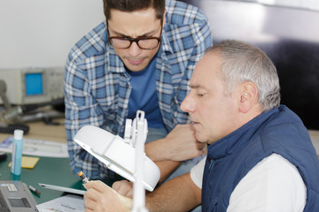 carpenter with apprentice in training period