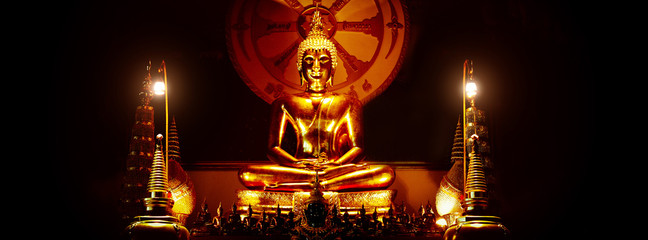 Golden Buddha Statue in Dark Background 