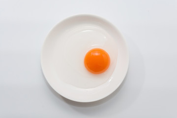 raw duck eggs in plate on white background