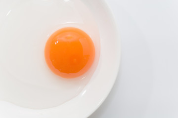 raw duck eggs in plate on white background