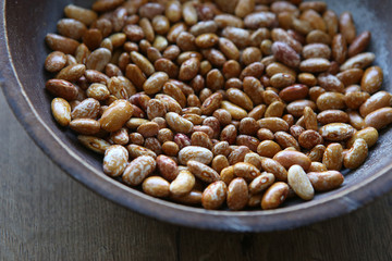 Pinto beans in bowl. Orange dried pinto beans.