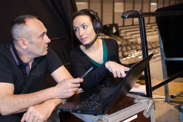 workers using a sound mixer with laptop