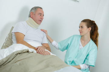 Obraz premium beautiful female nurse and an old man at the hospital