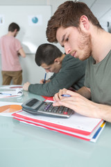 students with notebook and calculator at school