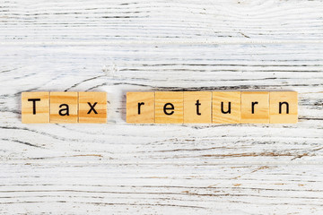 tax return word made with wooden blocks concept