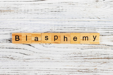 BLASPHEMY word made with wooden blocks concept