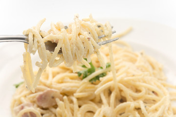 spaghetti carbonara with cream on white plate