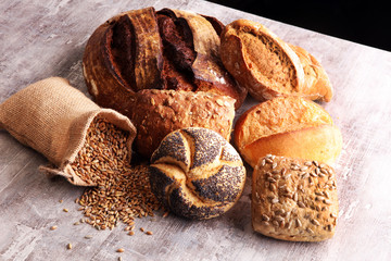 Different kinds of bread and bread rolls on board. Kitchen or bakery poster design.