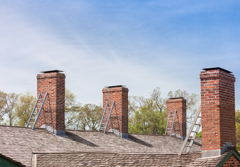 four chimneys with individual ladders on the roof