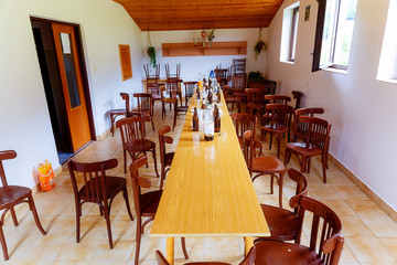 abandoned room with chairs, tables and and empty bottles after party being over.