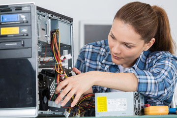 student girl in technology fixing computer hard drive