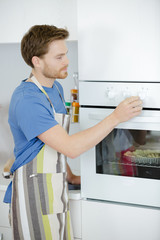 Man setting oven temperature