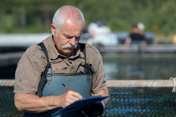 fish farmer writing notes