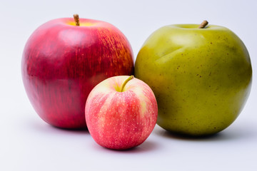 Small fresh apple with two large apples
