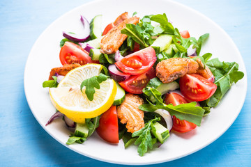 Fresh salad with salmon and vegetables.