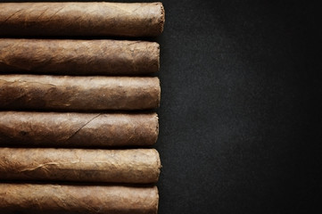 cigar on black background - obrazy, fototapety, plakaty