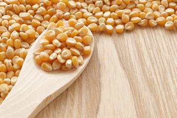 Pop corn corn on spoon and table