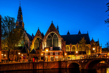 Fototapeta premium Night shot of the city, many bicycles on the bridge on Amsterdam canal, Netherlands