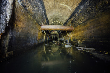 Flooded by wastewater big sewage collector. Dirty sewer tunnel under city