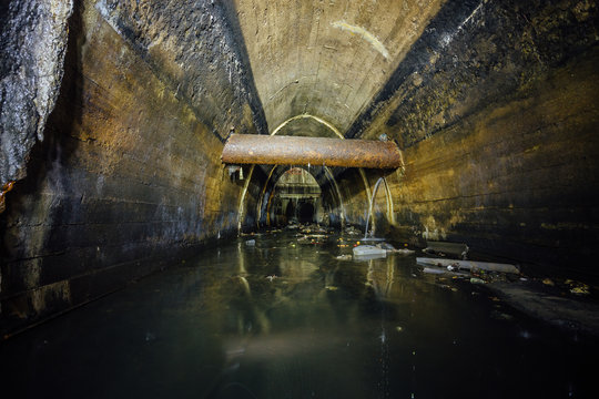 Flooded by wastewater big sewage collector. Dirty sewer tunnel under city