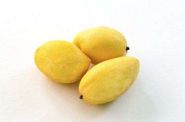 Yellow mango isolated on white background. Ripe golden mango studio photo for food package design