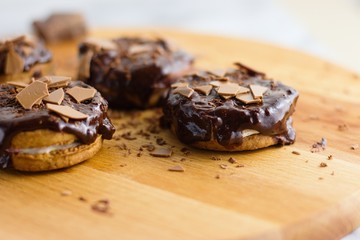 Cinnamon and marshmallow sandwich cookies topped by chocolate