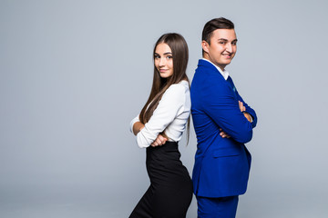 Two professionals in business and finance in gray jackets and jeans standing back-to-back on gray
