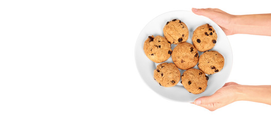 Pile of chocolate chip cookies on a dish in hand isolated on white background