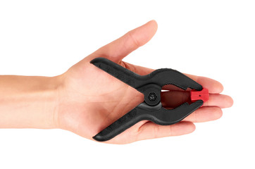 Black plastic clamp in hand isolated on white background