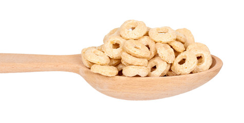 Heap cereals ring in wooden spoon isolated on white background