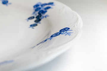Vintage porcelain dish close up. Beautiful blue flowers detail. © Cristina Jurca