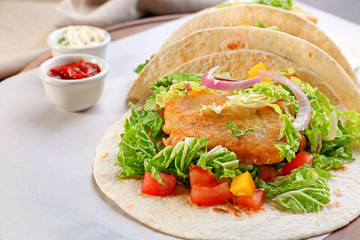 Delicious fish tacos on cooking sheet