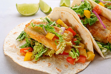 Delicious fish tacos on cooking sheet