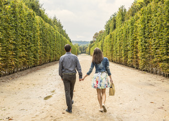 Obraz premium Couple Walking in a Garden