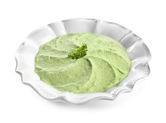 Plate with delicious broccoli soup on white background