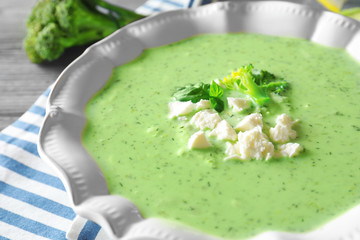 Closeup of plate with delicious broccoli soup on table