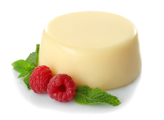 Delicious vanilla pudding with raspberries on white background