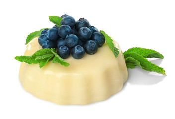 Delicious vanilla pudding with berries on white background